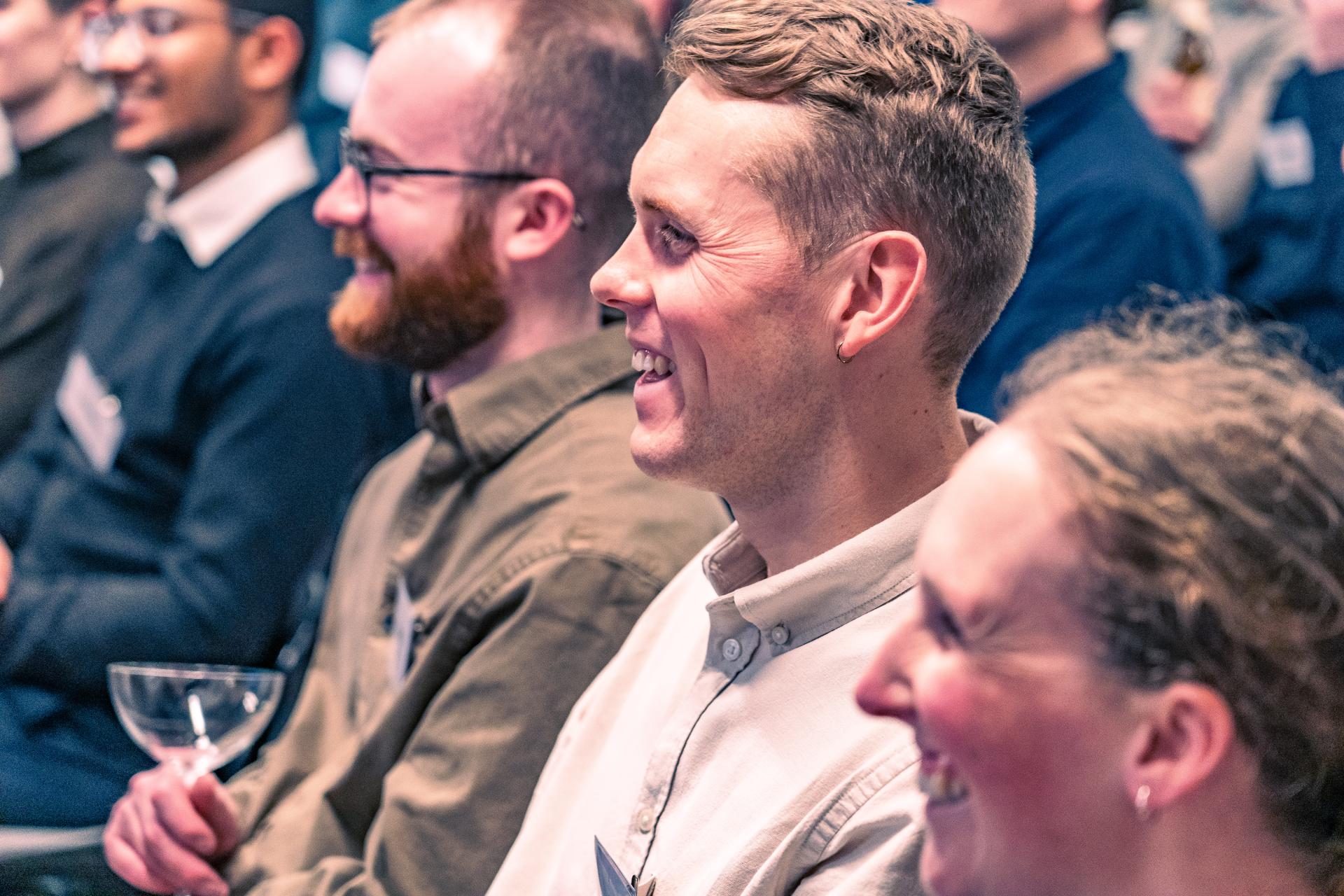 Engaged audience members at a seminar discussing net zero carbon buildings, showcasing collaboration and interest in sustainability.