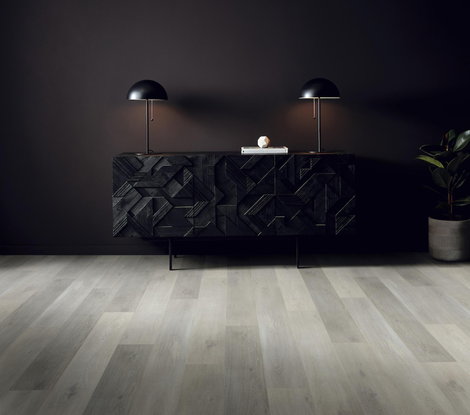 Contemporary interior featuring Karndean's Korlok Regent flooring, sleek black furniture, and stylish lighting for a modern aesthetic.