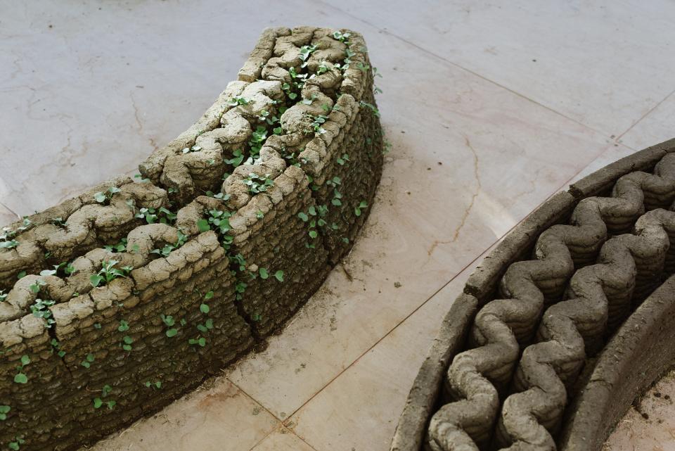Innovative 3D-printed structure with greenery, showcasing sustainable architecture techniques at Jerusalem Design Week 2022.