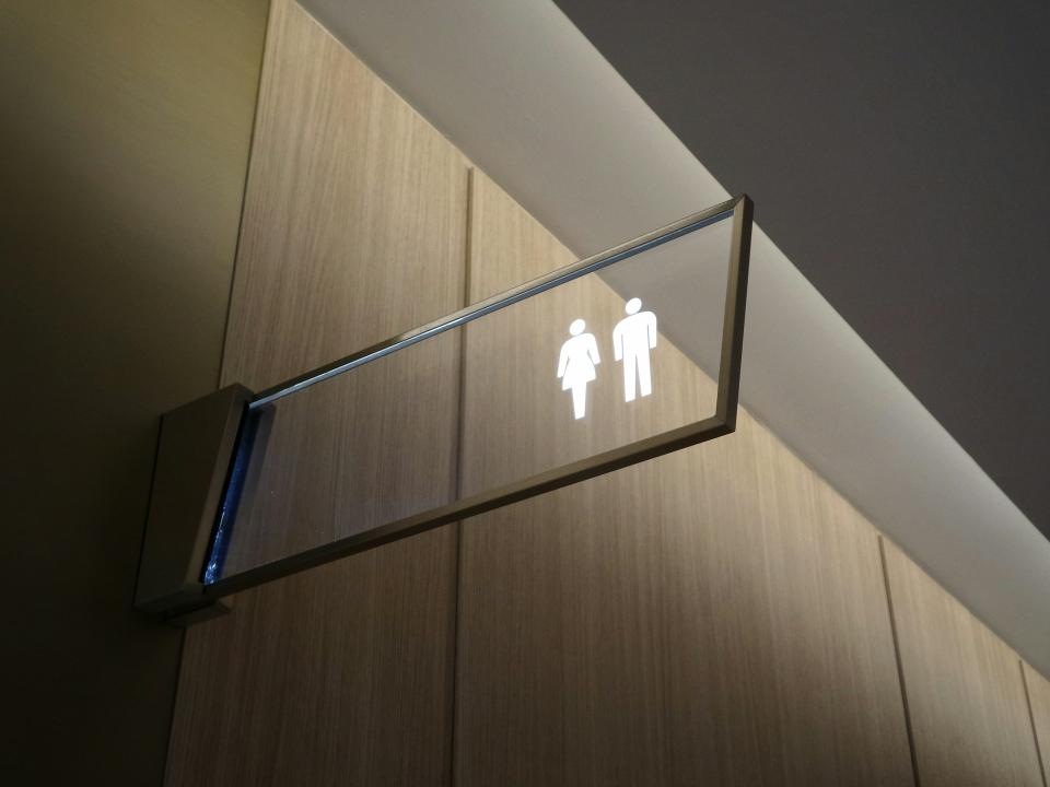Signage indicating gendered restrooms, highlighting compliance with accessibility and building regulations ahead of Part T implementation.