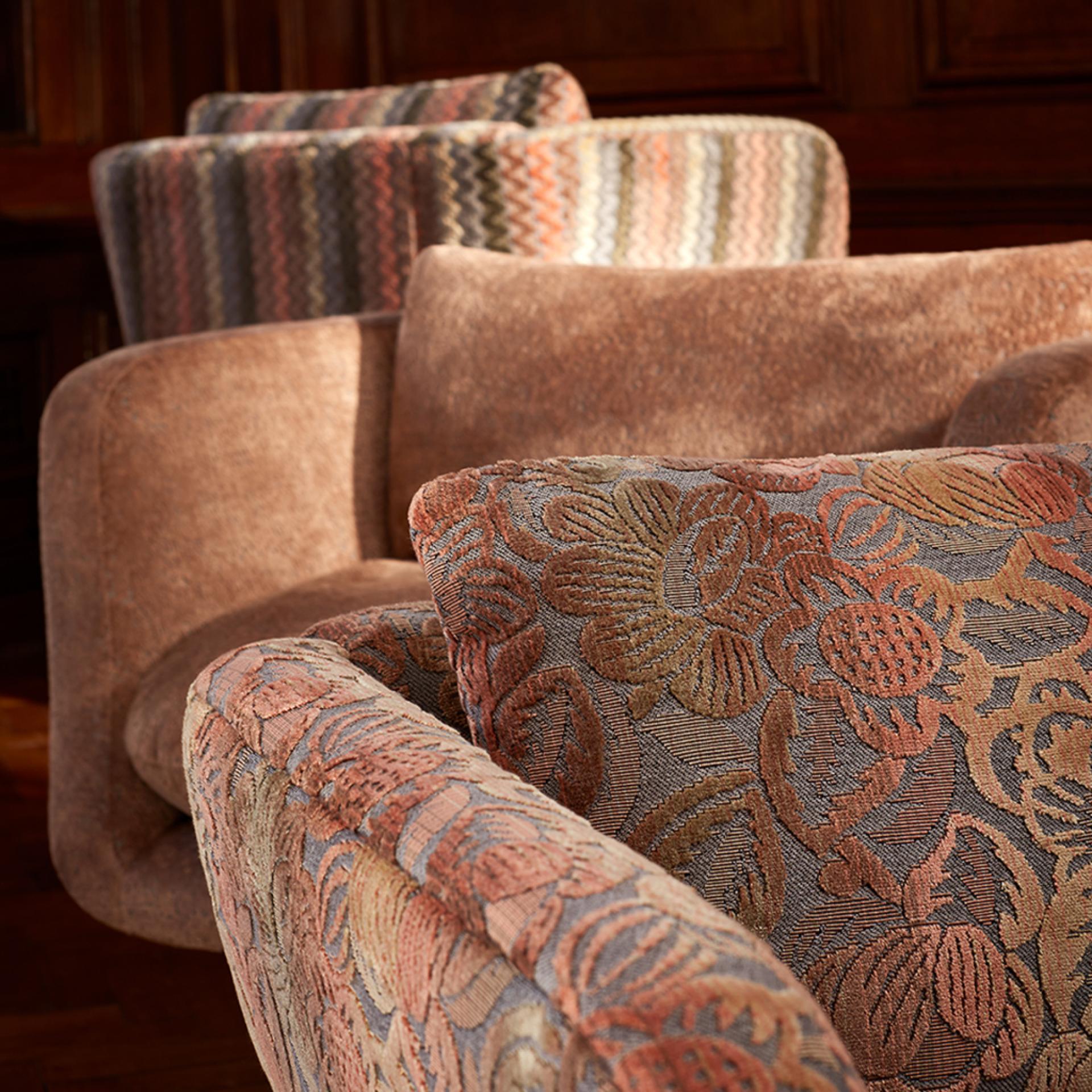 Luxurious armchairs featuring bold floral and geometric patterns, inspired by Art Deco aesthetics from the Parisienne Collection.