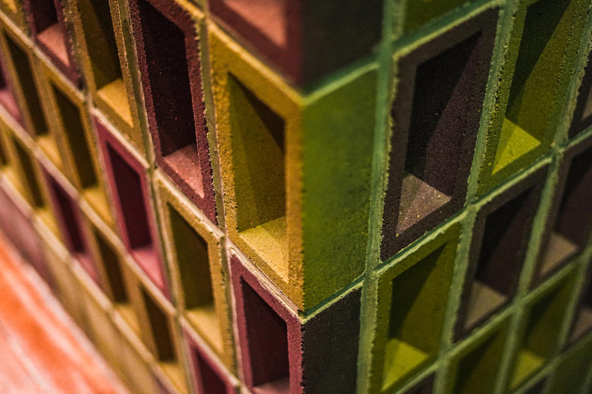K-BRIQ display showcasing unique, eco-friendly bricks in various colors, highlighting Kenoteq's sustainable construction materials.