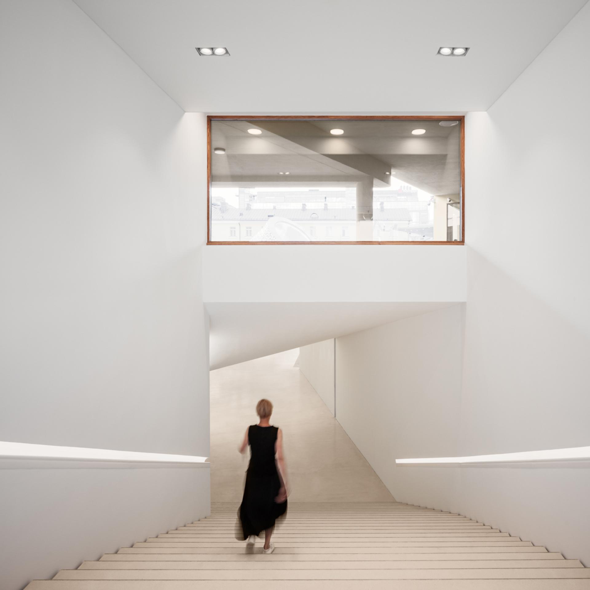Minimalist staircase leading to Helsinki's new art museum, showcasing modern architecture and bright, open spaces.