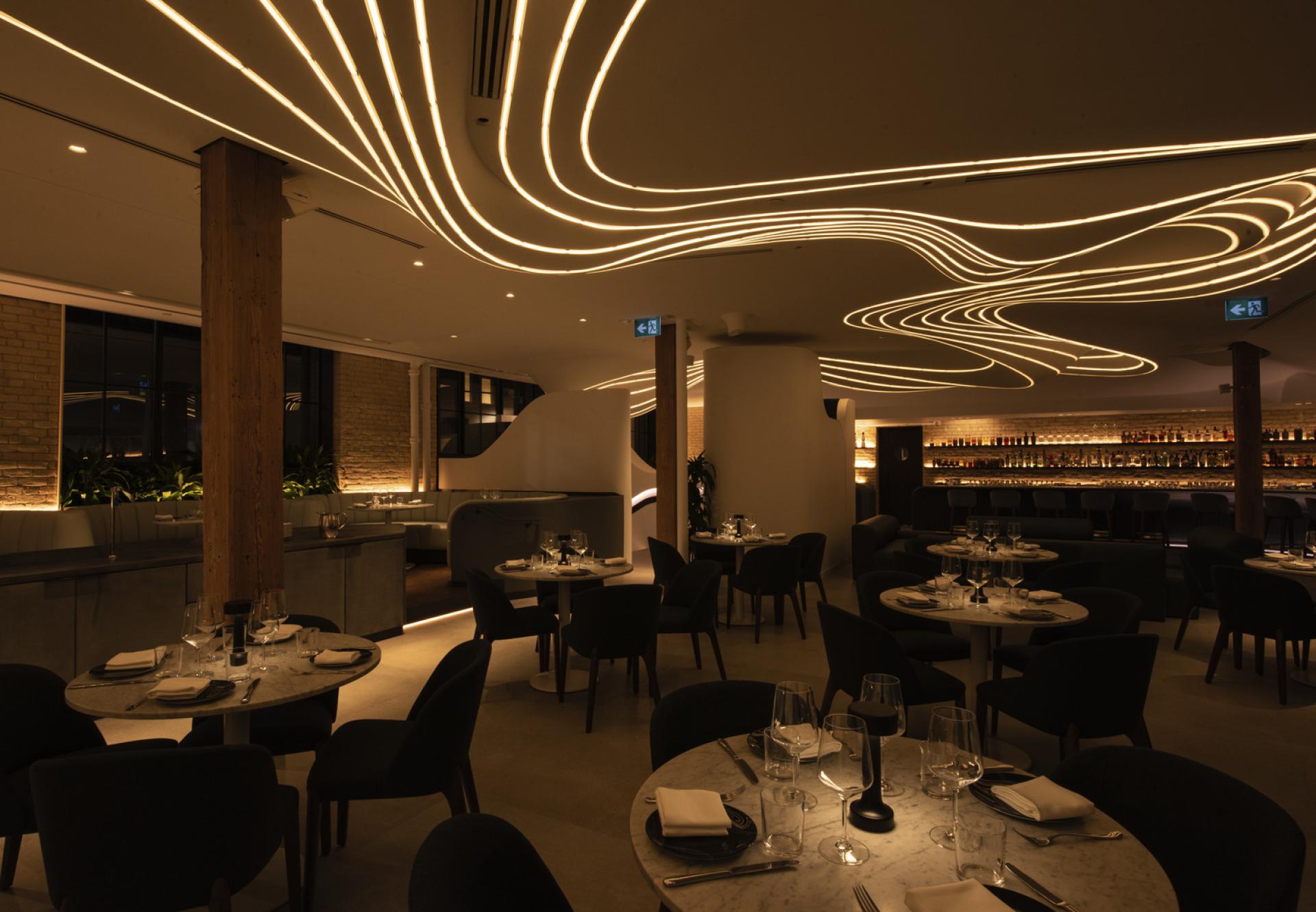 Elegant restaurant interior of VELA featuring cozy seating and artistic lighting inspired by a constellation of stars.