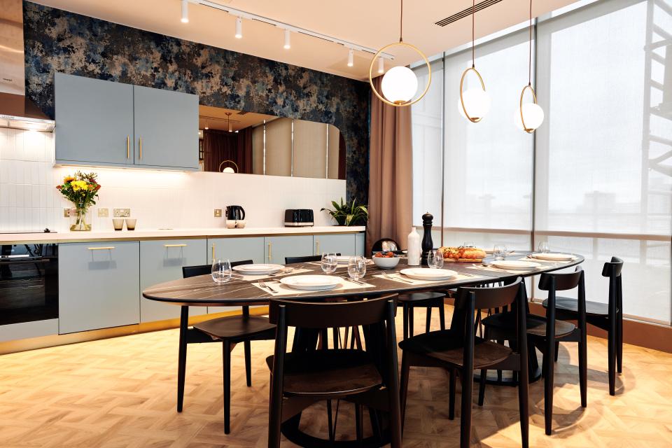 Modern kitchen and dining area featuring elegant decor and amenities in a residential space designed by 74 for Grainger plc.