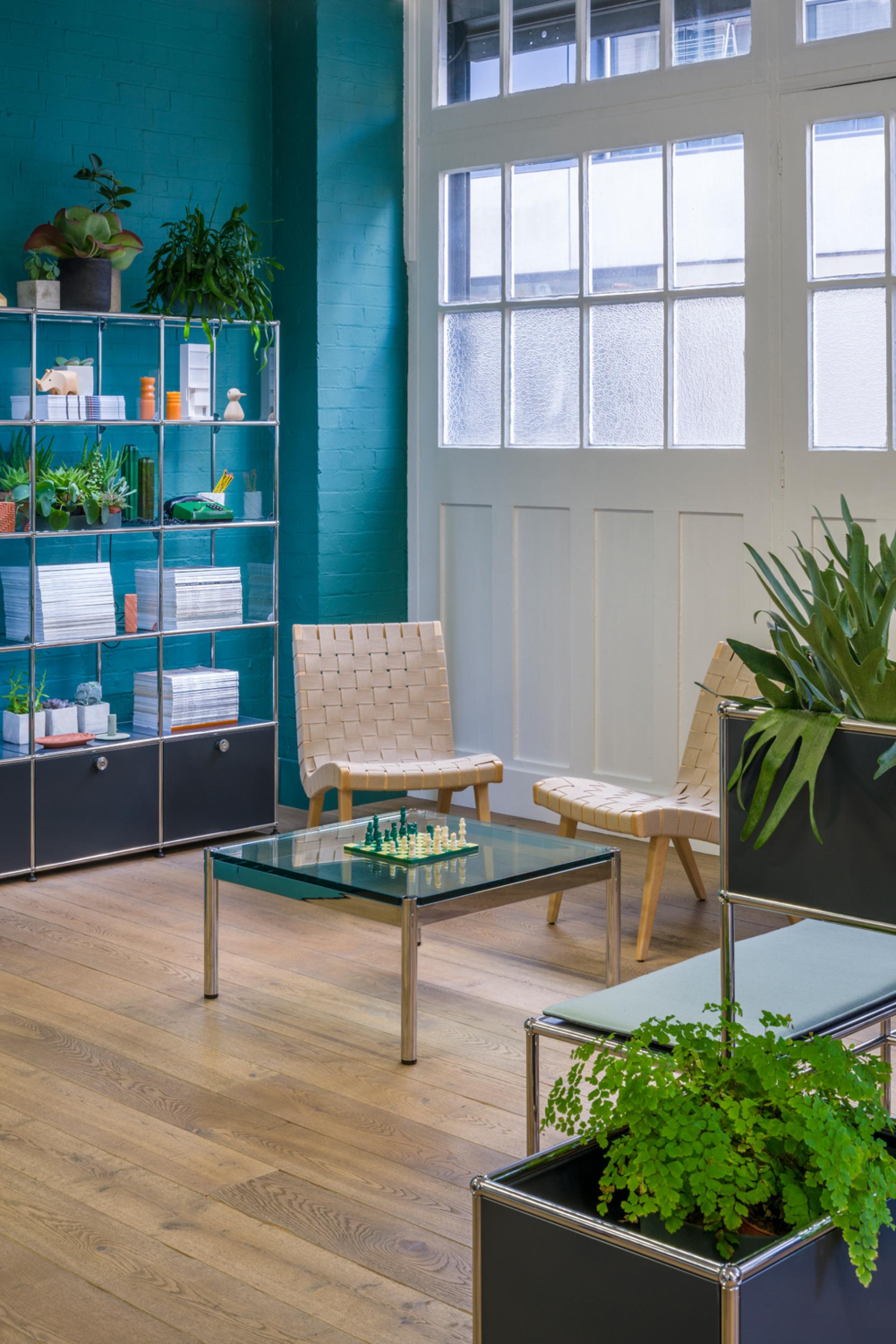 Stylish modular furniture in USM's revamped Clerkenwell showroom, featuring vibrant decor and greenery for a versatile look.