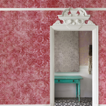 Traditional V&A wallpaper design in a pink room, showcasing a decorative mirror and turquoise table against patterned flooring.