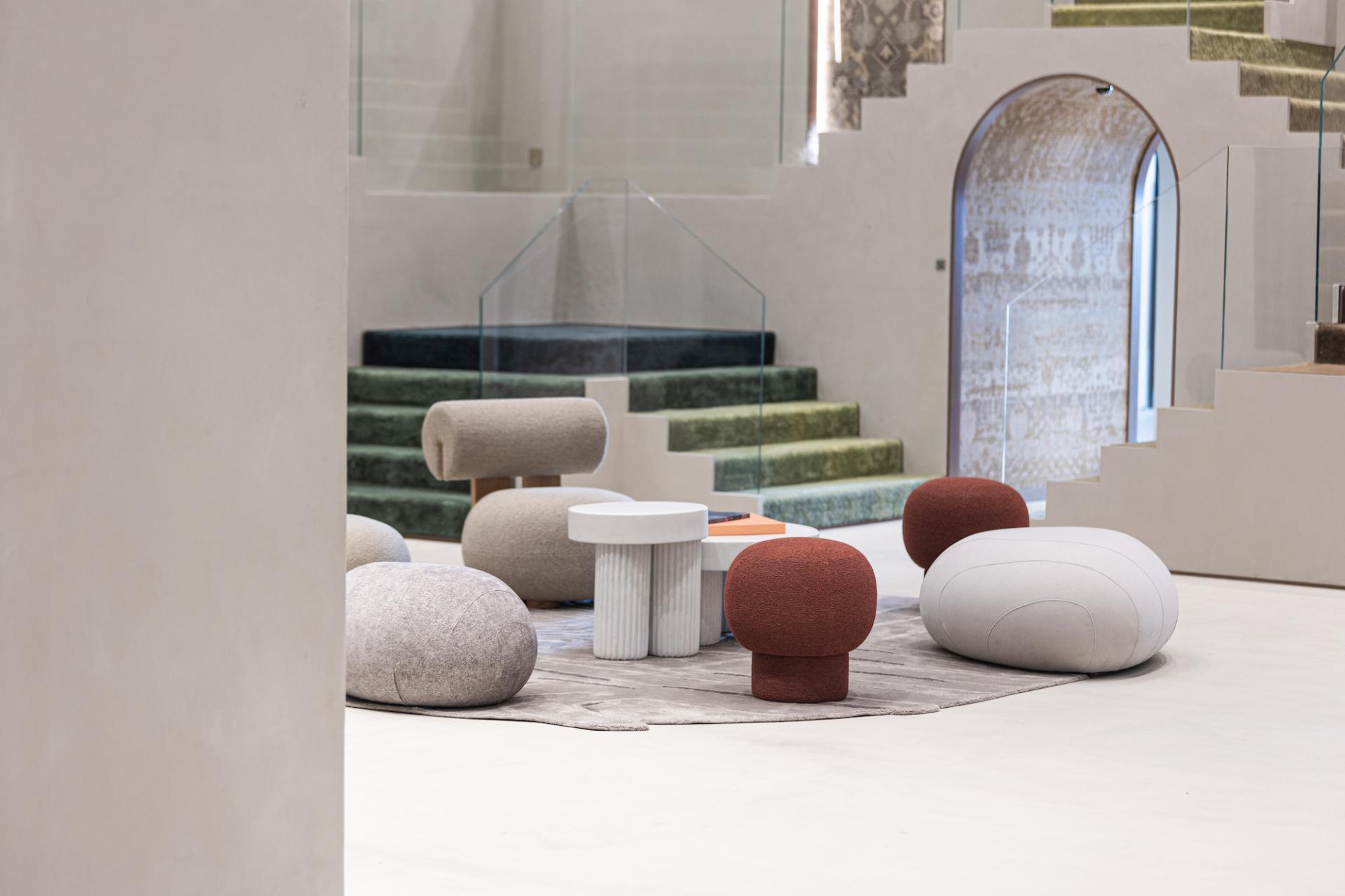 Modern seating arrangements inspired by Rajasthani design in Jaipur Rugs' Dubai showroom, showcasing unique shapes and textures.