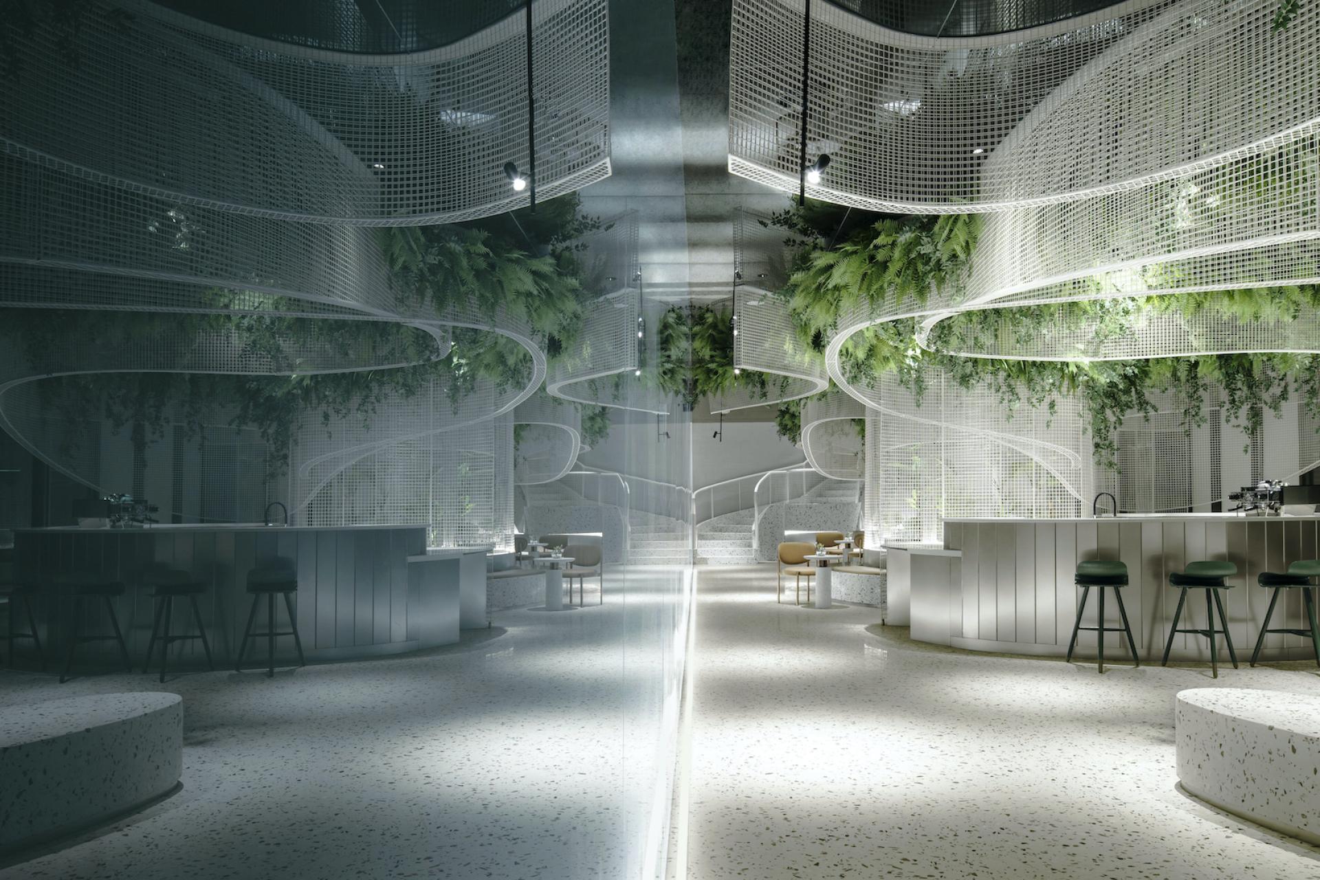 A stylish café interior featuring terrazzo flooring, curved mesh grids, and lush greenery, designed by Karv One.