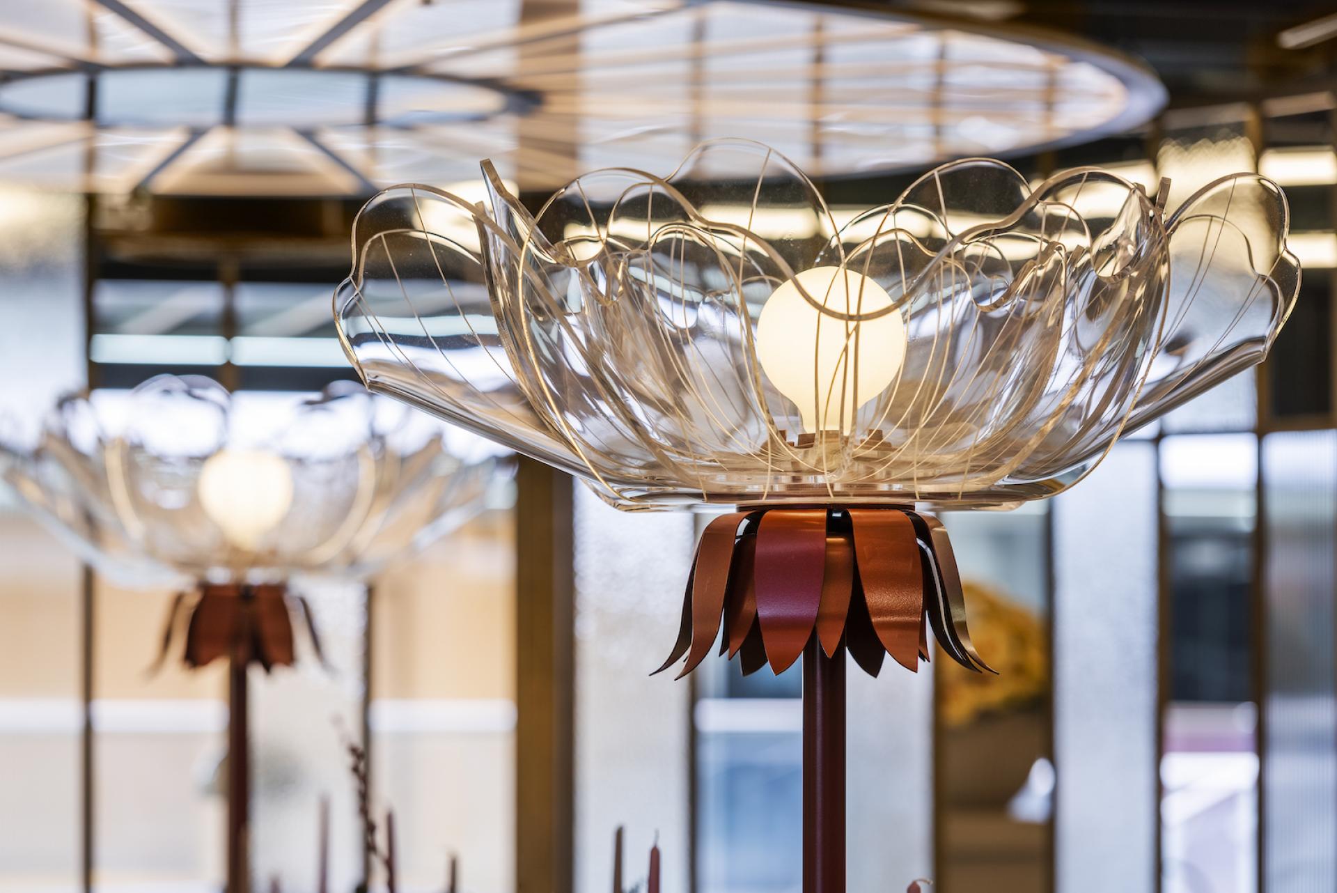 Elegant floral-inspired lighting fixture in a whimsical setting, embodying the creative spirit of Wonderland.
