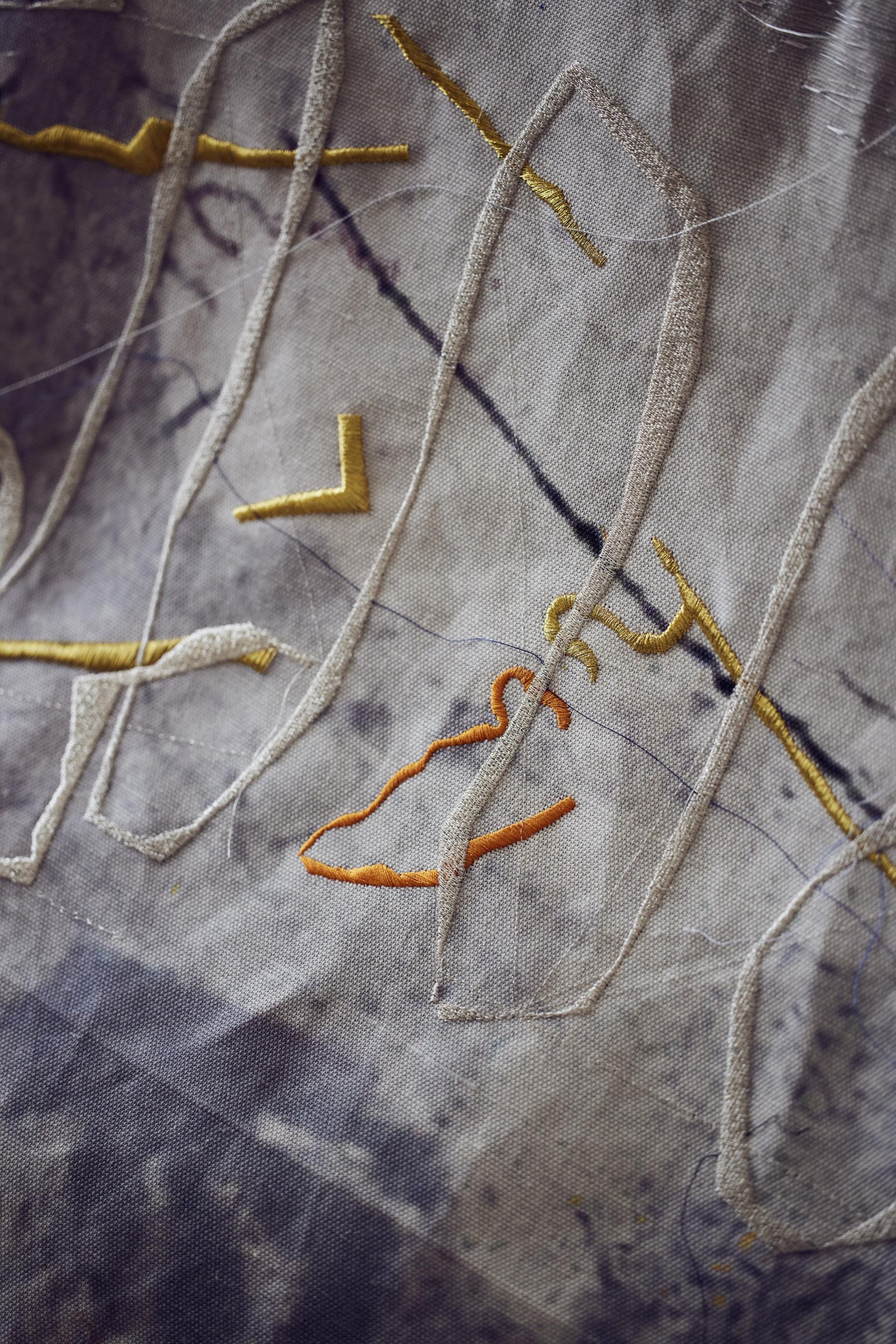 Embroidery detail featuring vibrant threads on fabric, showcasing the innovative textile art of Manchester-based artist Alice Kettle.