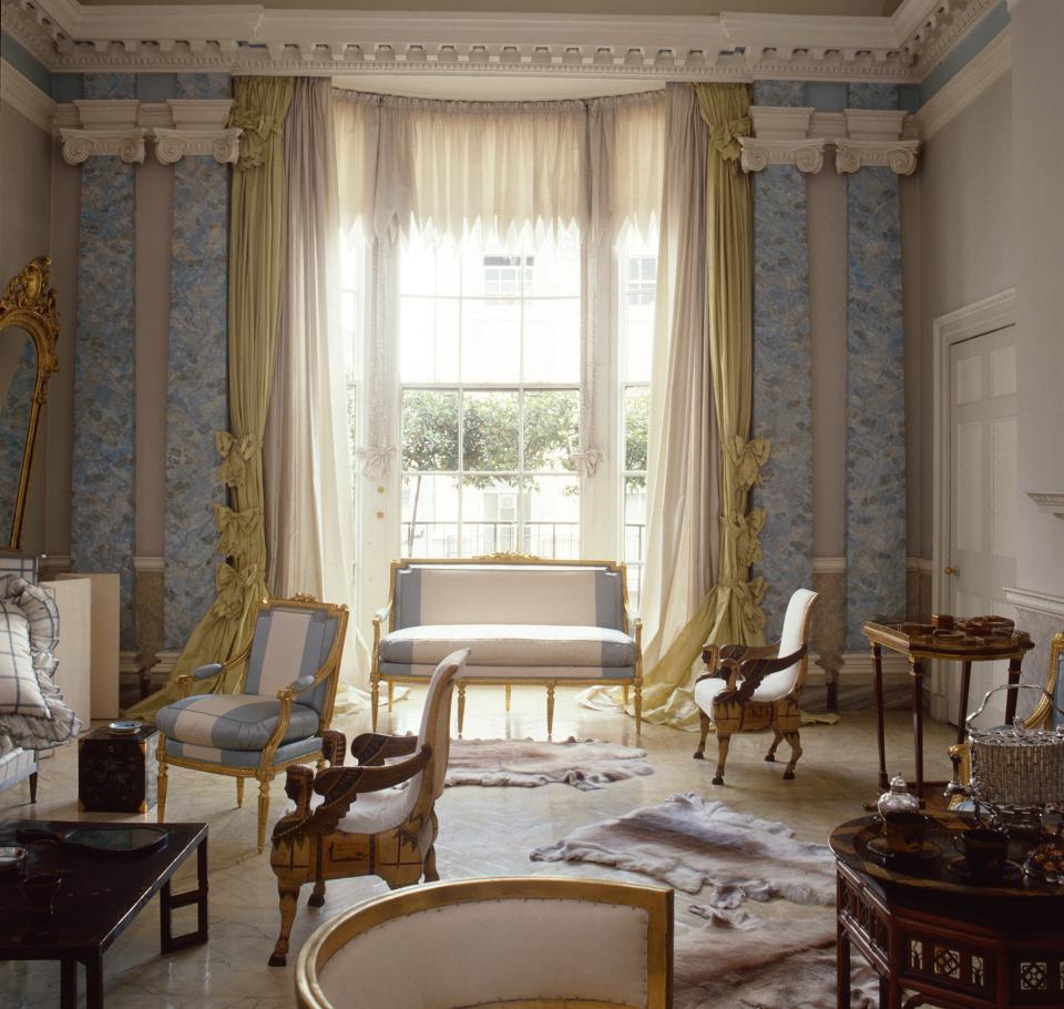 Elegant interior showcasing luxurious furniture and soft light streaming through large windows in a British home.