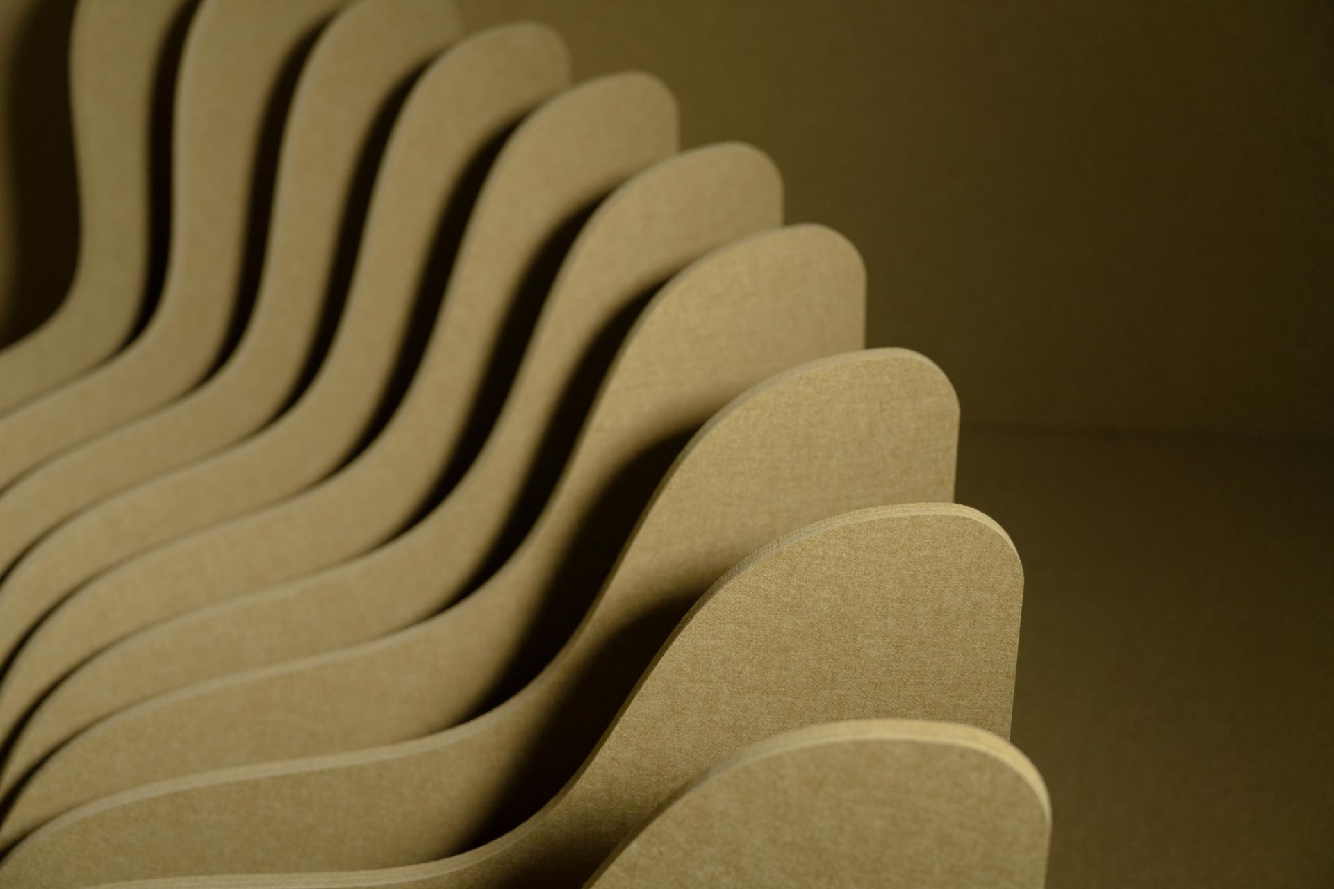 Curved acoustical panels in natural tones, inspired by global landscapes, showcasing Autex Acoustics' new color offerings.