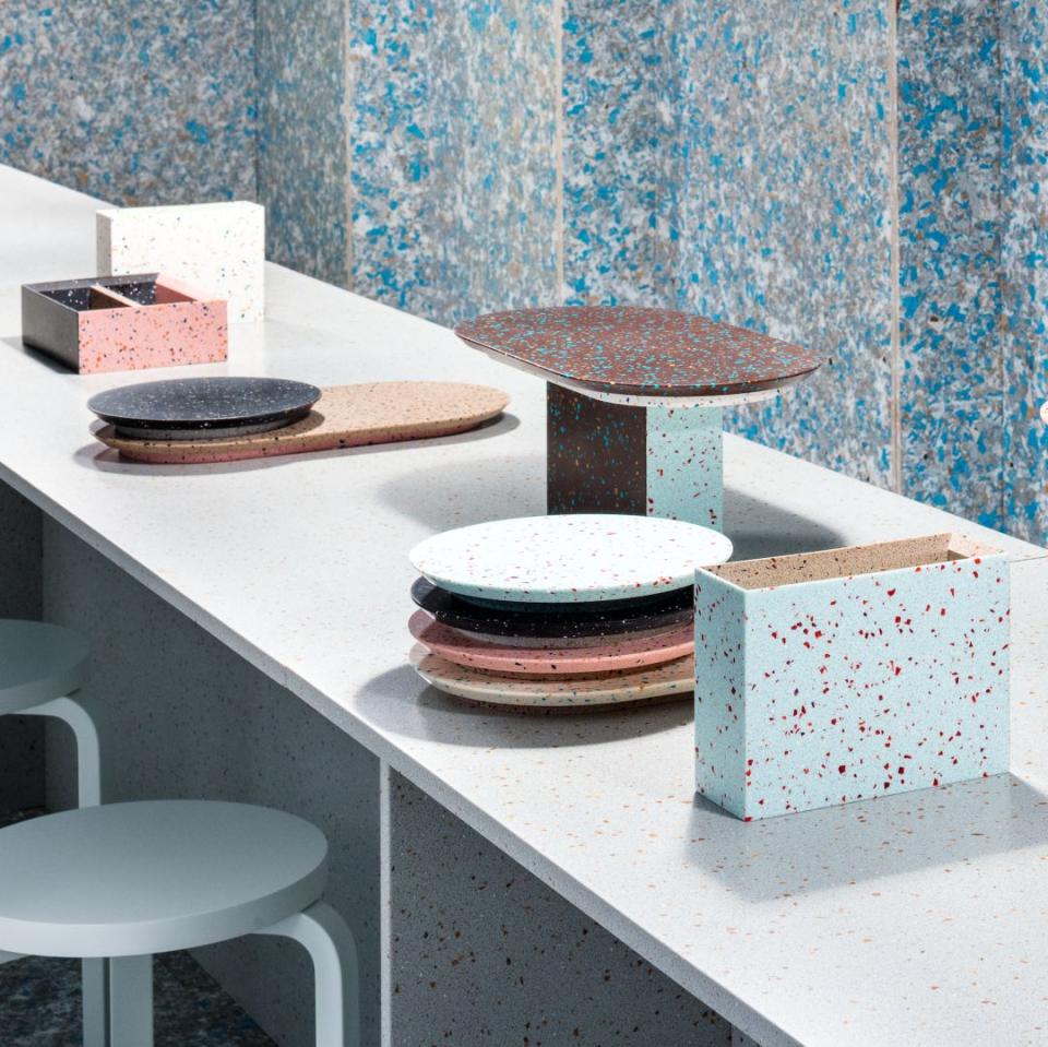 Colorful, speckled tableware made from eco-friendly materials displayed on a modern countertop in Linda Bergroth's Zero Waste Bistro.