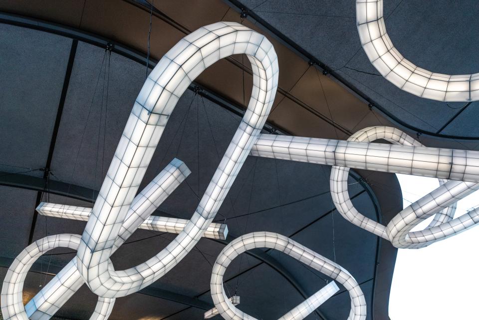 Sculptural lighting installation by Studio Mieke Meijer featuring intertwined, illuminated designs at Coal Drops Yard.