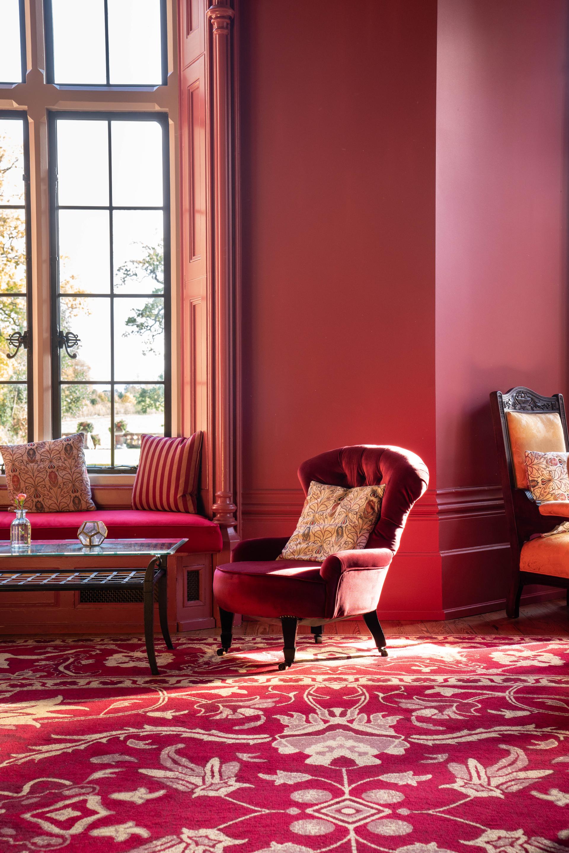 Luxurious interior of The Elvetham, featuring ornate red carpet and elegant seating, highlighting premium Ege carpets.
