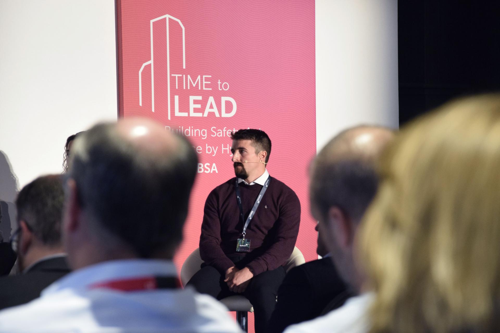 Darren Agnew participates in a panel discussing innovative fire safety solutions at a building safety conference.