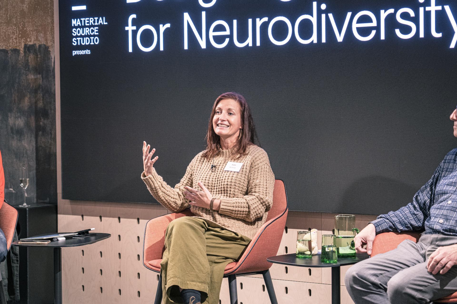 Presenter discussing neurodiversity design principles during the Material Source Studio seminar, with engaged audience members.