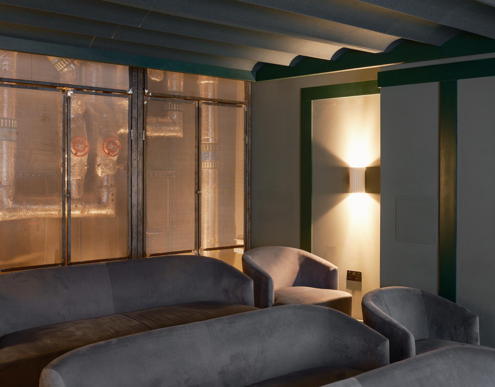 Contemporary lounge area with velvet sofas and modern lighting, reflecting the iQ East Court amenities inspired by Mile End design.