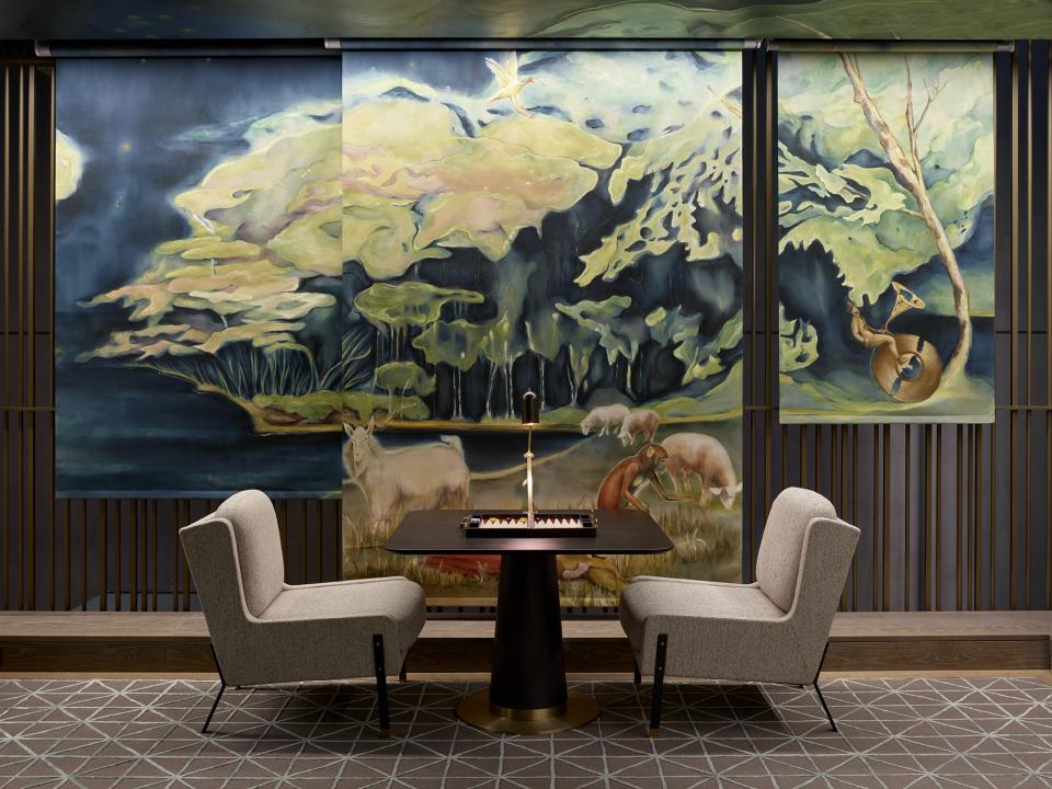 The interior of a Leicester Square hotel featuring a vivid mural and stylish seating, designed by Yabu Pushelberg.