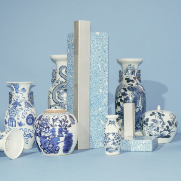 Decorative blue and white vases displayed with modern geometric pieces in a stylistic arrangement, showcasing Copenhagen's Tableau studio design.