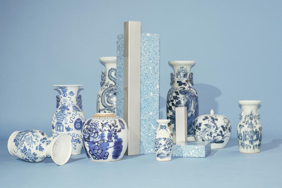 Decorative blue and white vases displayed with modern geometric pieces in a stylistic arrangement, showcasing Copenhagen's Tableau studio design.