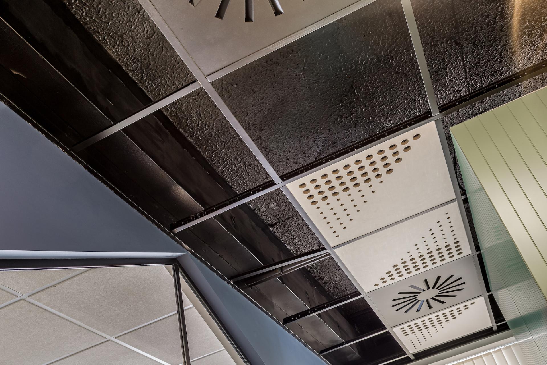Modern office ceiling design featuring textured panels and acoustic elements, showcasing Align's innovative workplace solutions at Lexis Nexis.