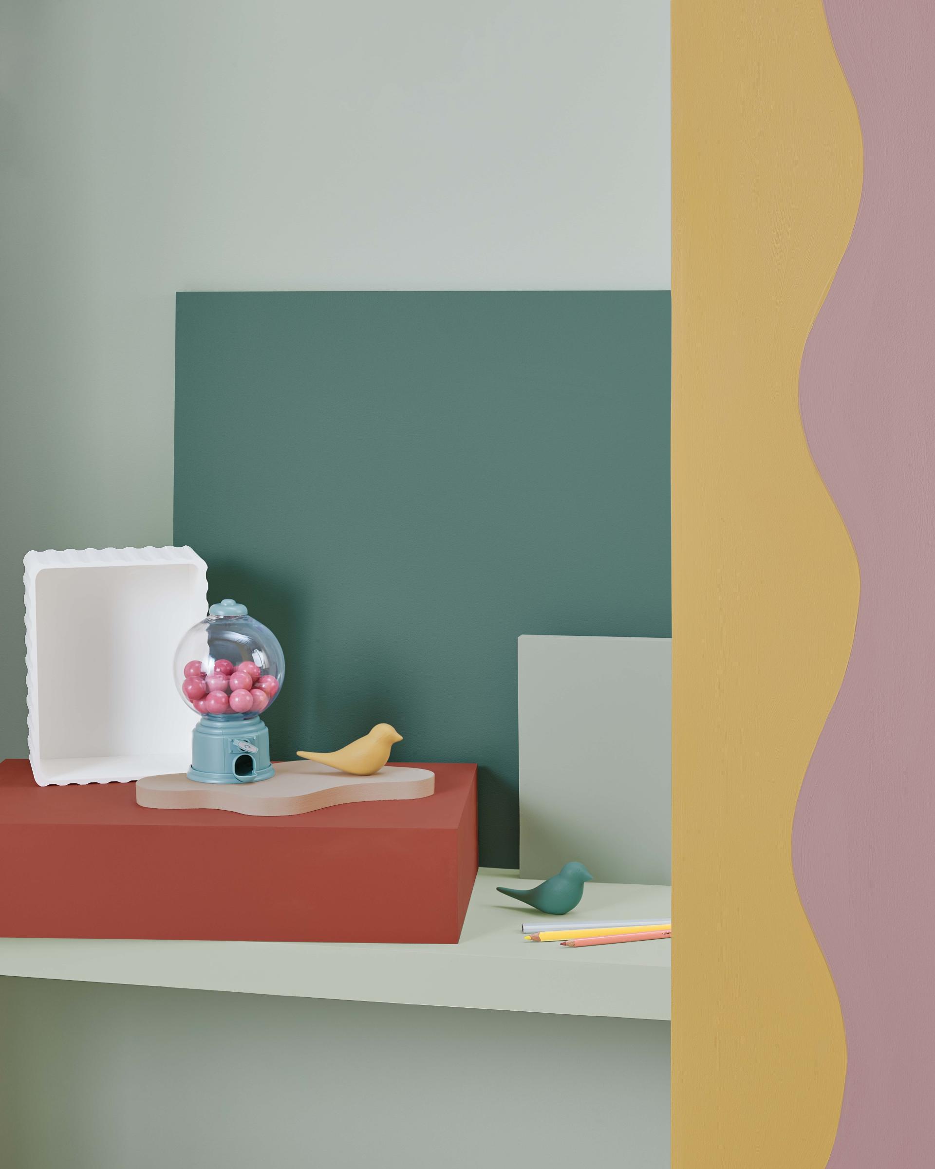 Brightly colored decorative items on display, showcasing Crown Paints' Colour Insights for 2024/25 in a stylish studio setting.