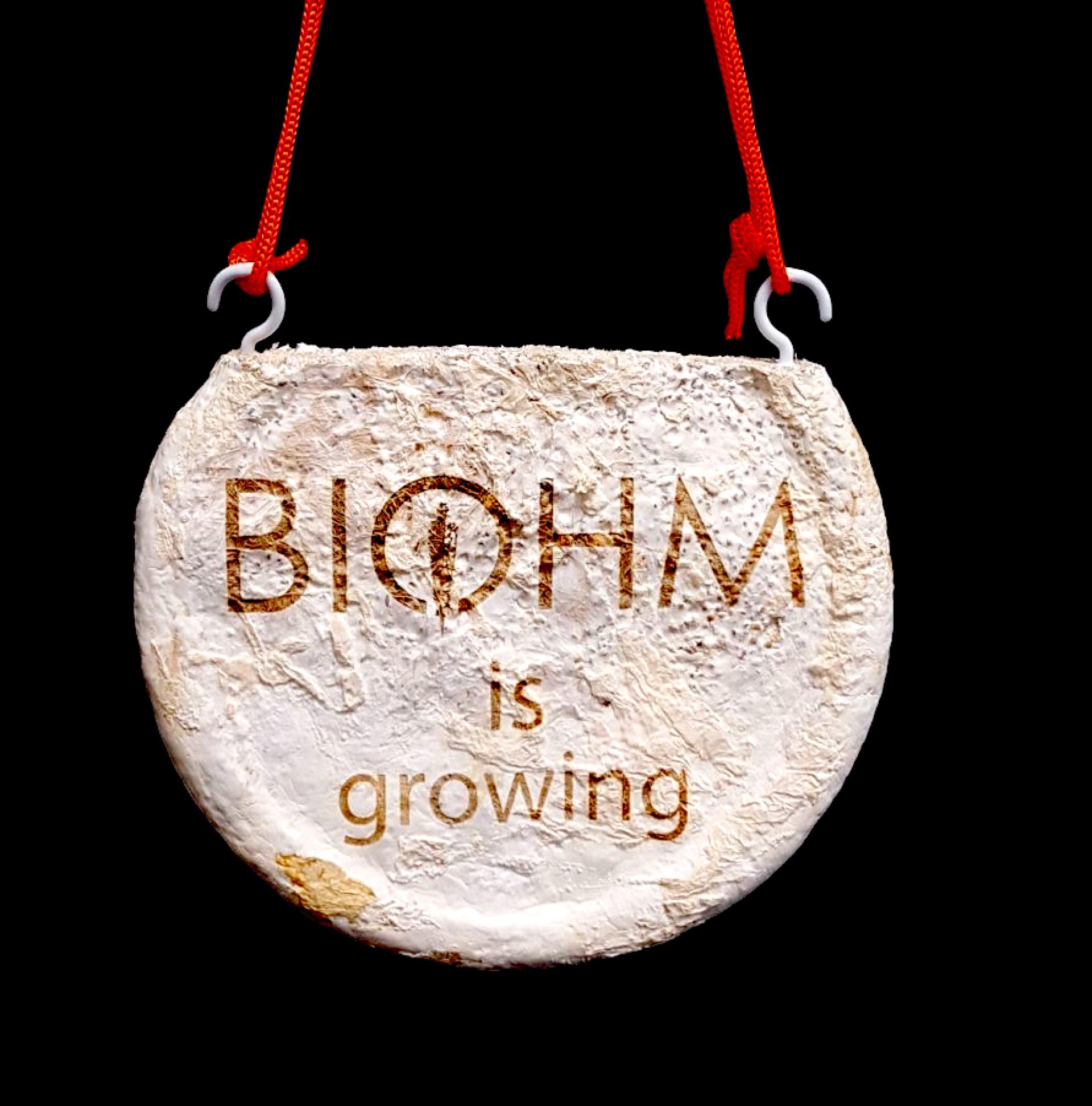 BIOHM brand sign stating "BIOHM is growing," symbolizing their innovative growth and commitment to sustainability.