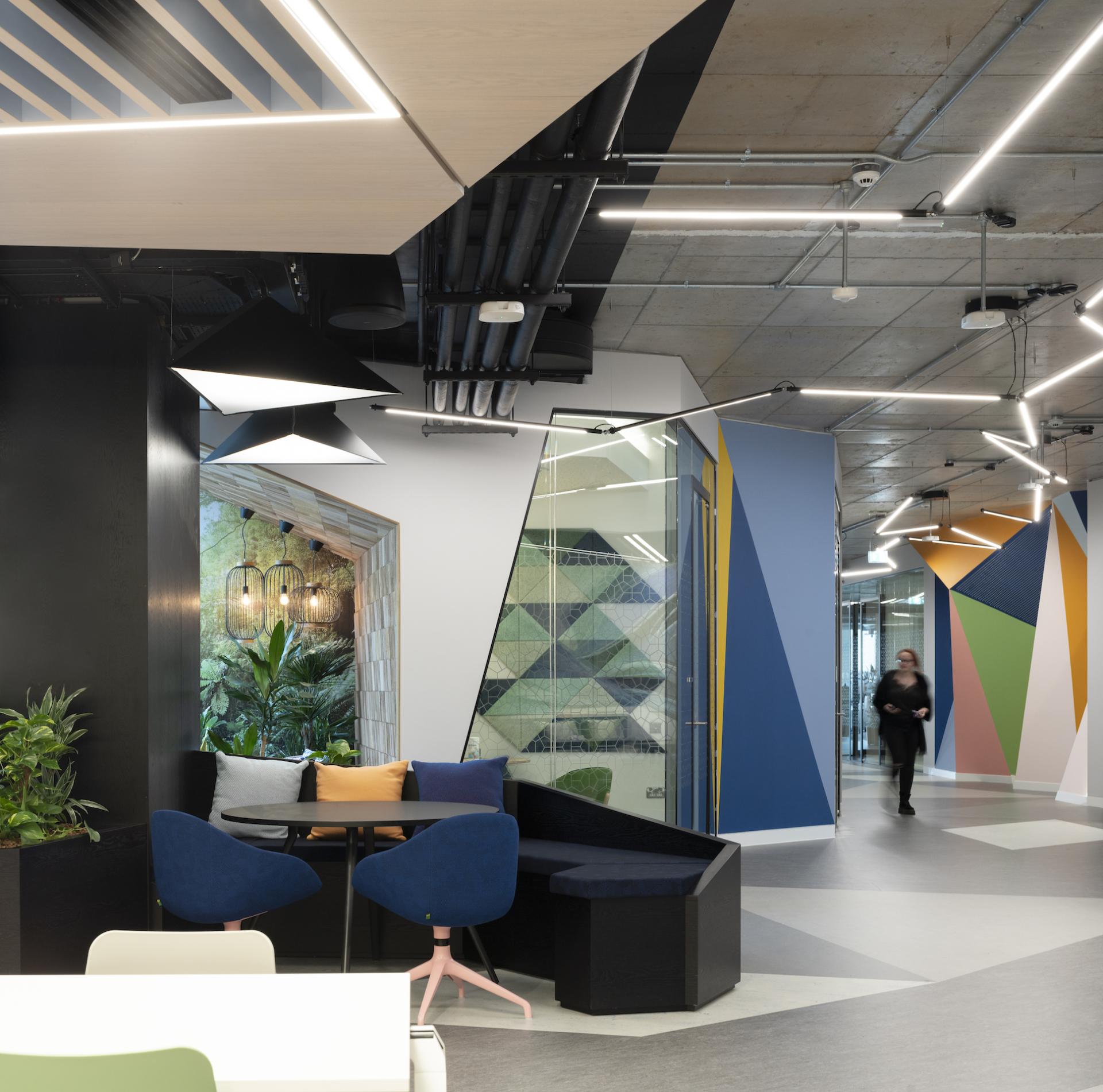 Brightly designed interior of Autodesk Dublin headquarters featuring modern lighting and geometric wall patterns.