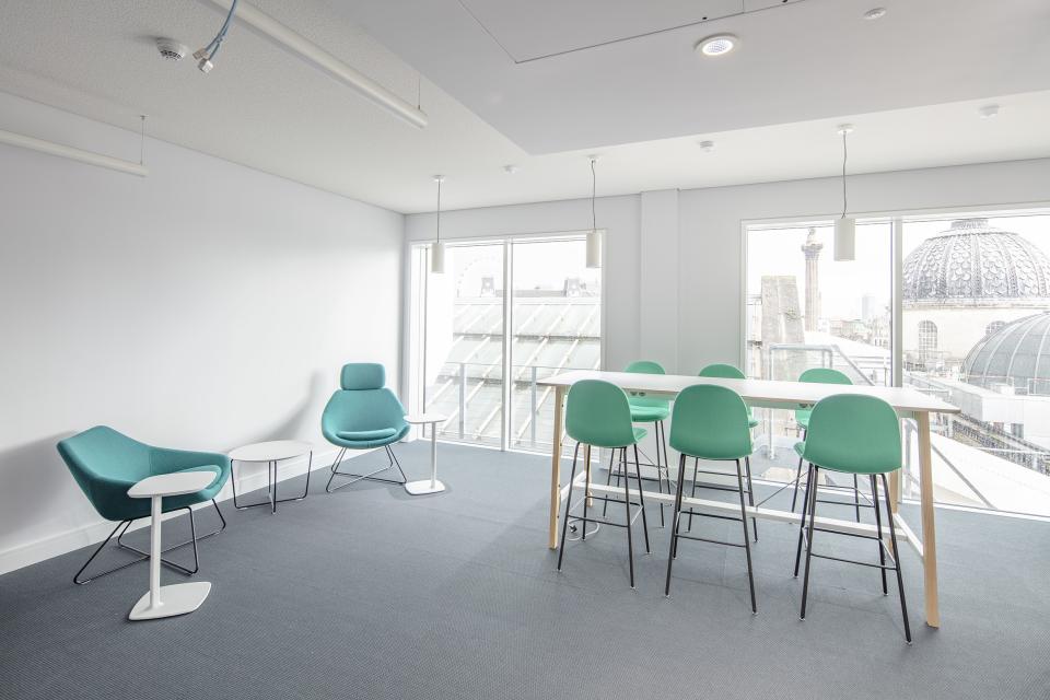 Modern office space in The National Gallery’s One Accommodation Hub, featuring stylish seating and large windows with views.