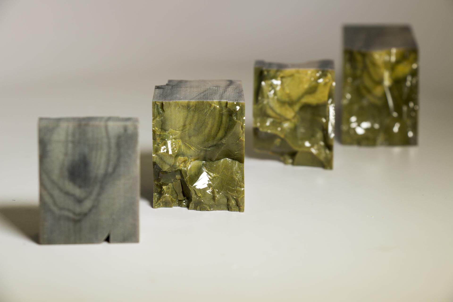 Sustainable alternative materials resembling wood, showcasing a gradient of colors and textures in block forms.