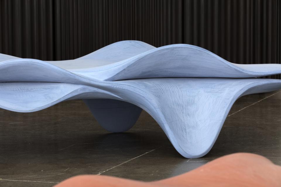 Contemporary sculptural furniture inspired by the traditional Birdcage Windsor chair, featuring fluid, wave-like designs.