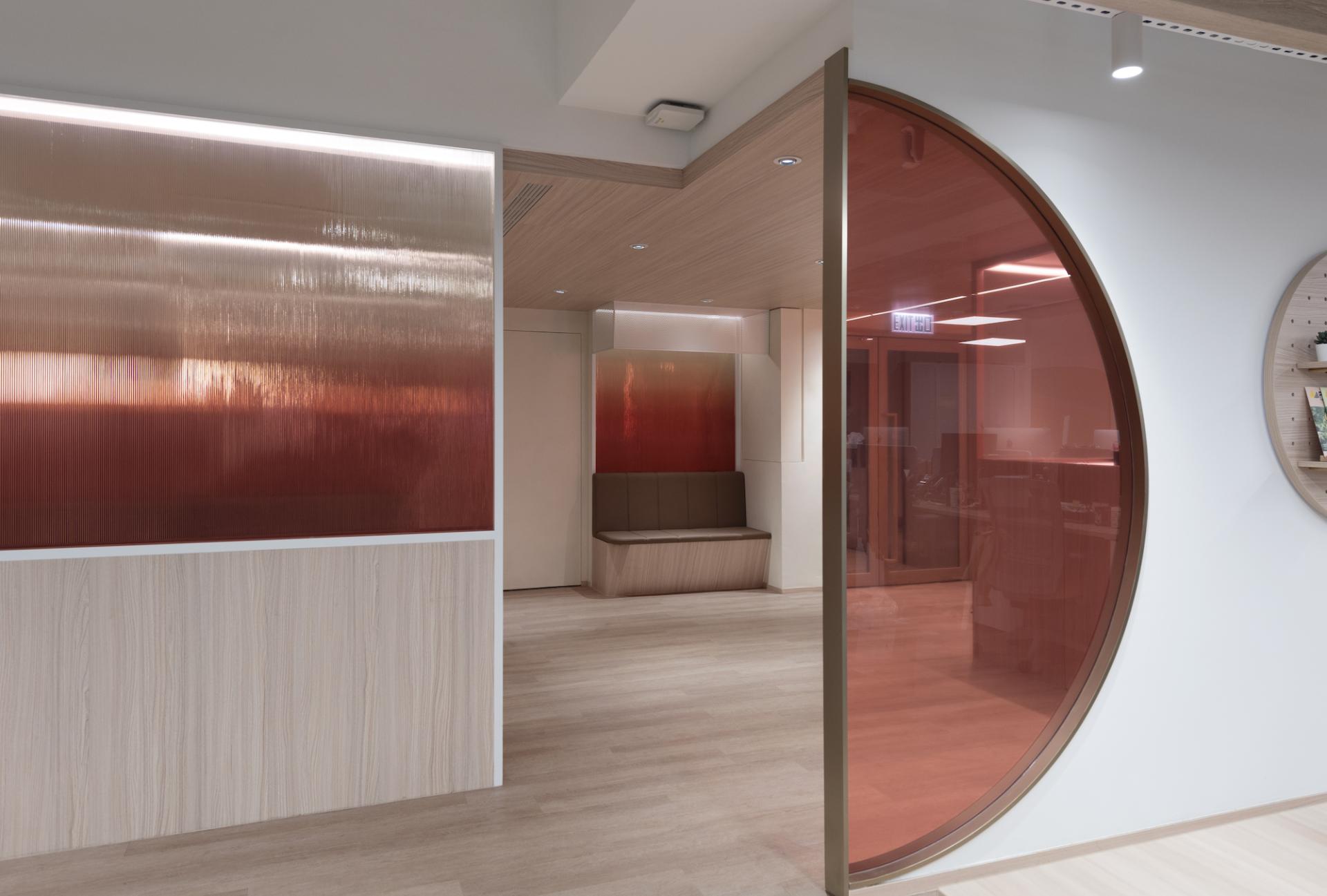 Modern office interior of Unicorn Stores HQ featuring minimalist design with natural wood and decorative glass elements.