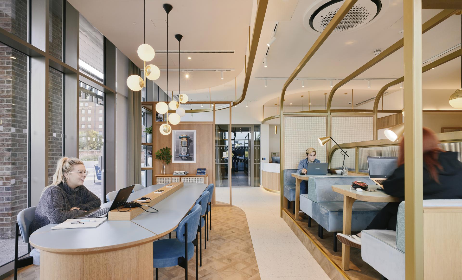 Modern residential amenity space at The Headline, Leeds, featuring stylish workstations and contemporary design elements.