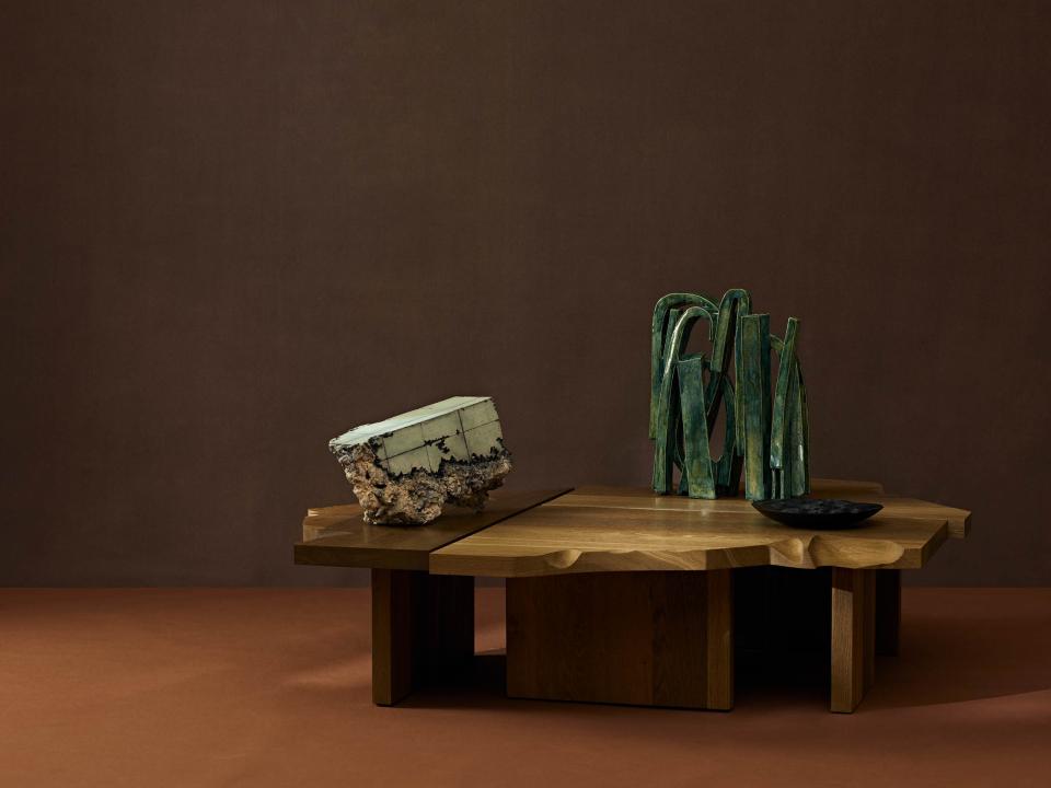Artistic display of modern sculptures and unique wooden furniture, showcasing craftsmanship at the Collect 2025 exhibition.