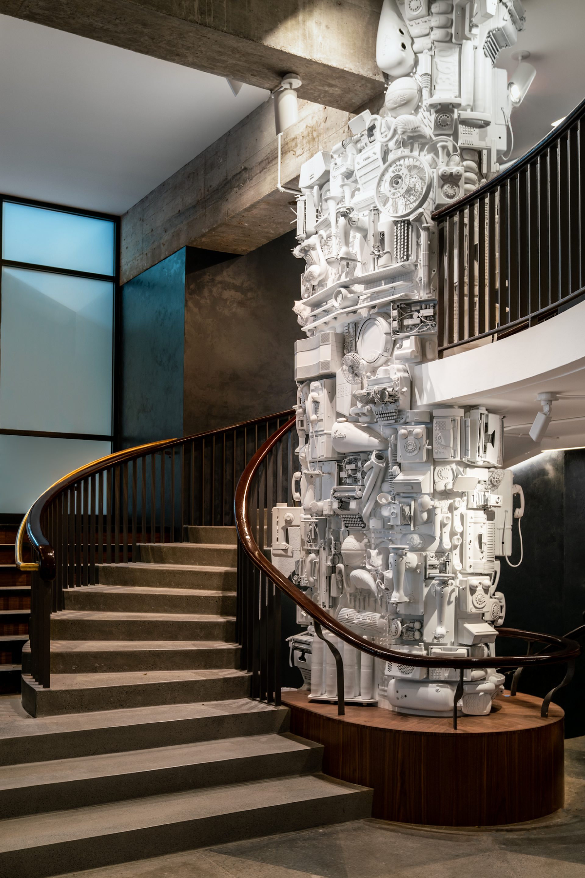 Spiral staircase leading to a unique white sculpture, showcasing Adam&Co.'s innovative design at The Revolution Hotel, Boston.