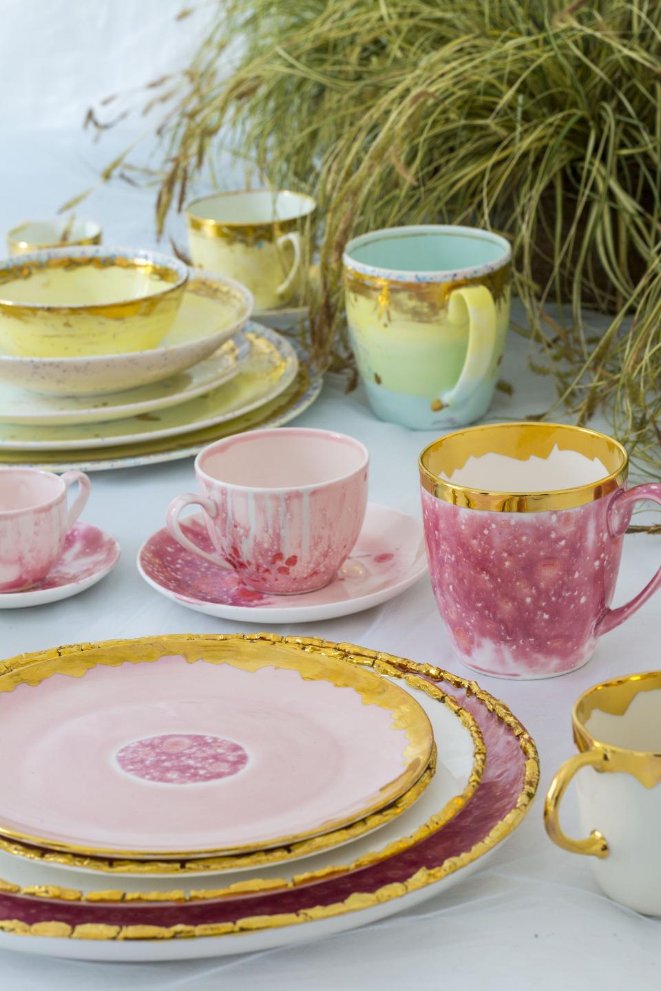 Hand-decorated ceramic and porcelain tableware by Coralla Maiuri, featuring vibrant colors and gold accents.