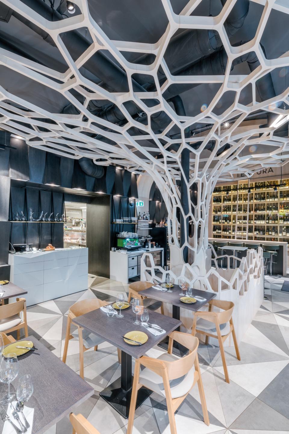Modern dining area at Textúra restaurant featuring parametric design with intricate ceiling elements and stylish furnishings.