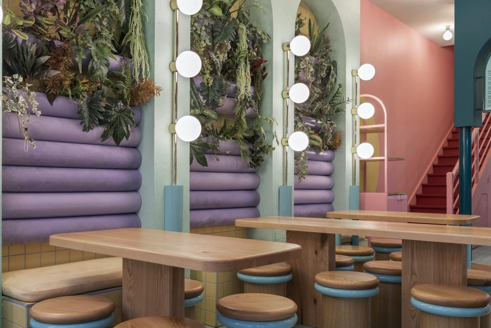 Lyon's Piada shop features a vibrant candy color palette with greenery, modern lighting, and stylish wooden furniture.