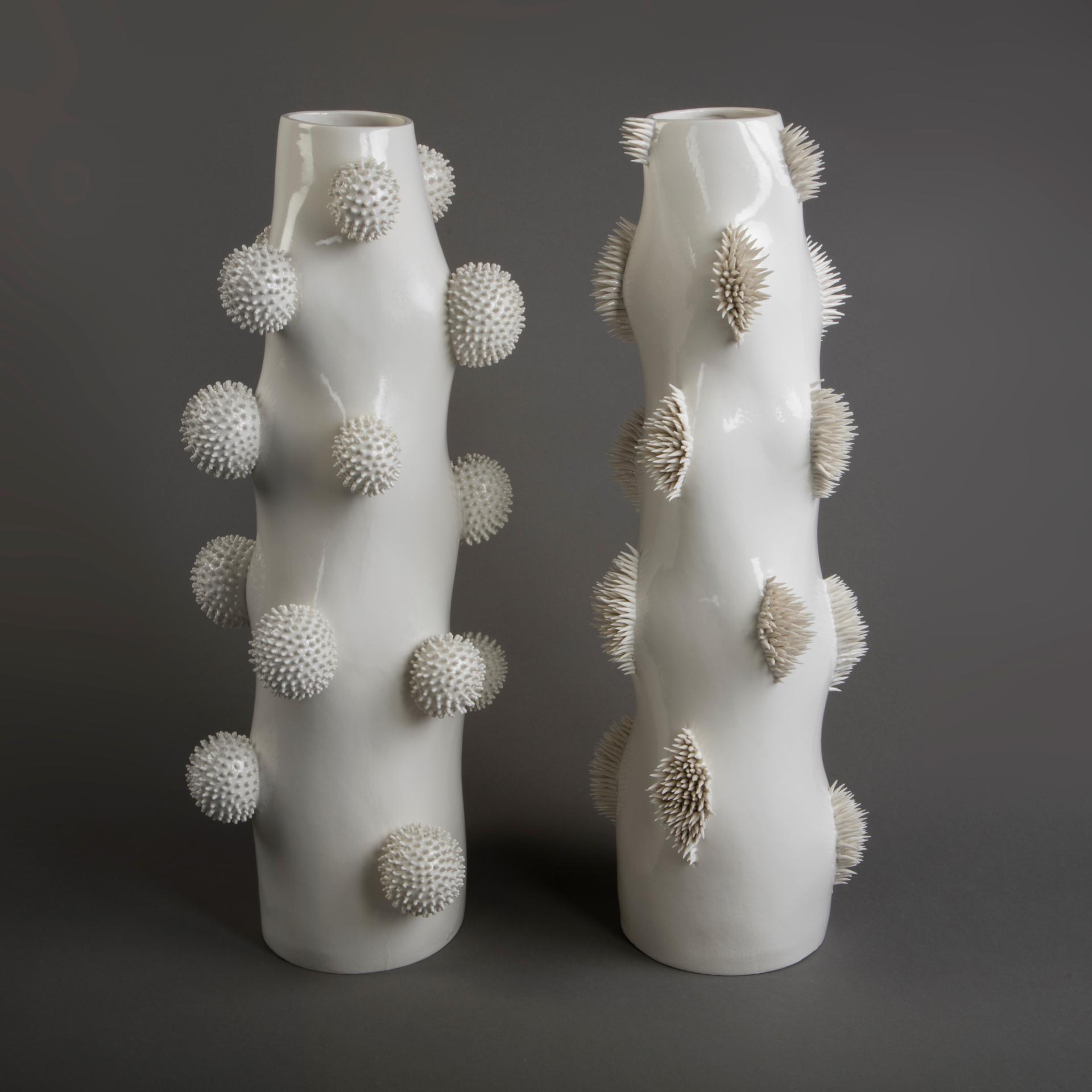 Ceramic vases with textured white surfaces, featuring clusters of spherical and spiky forms, displayed at the London Art Fair.