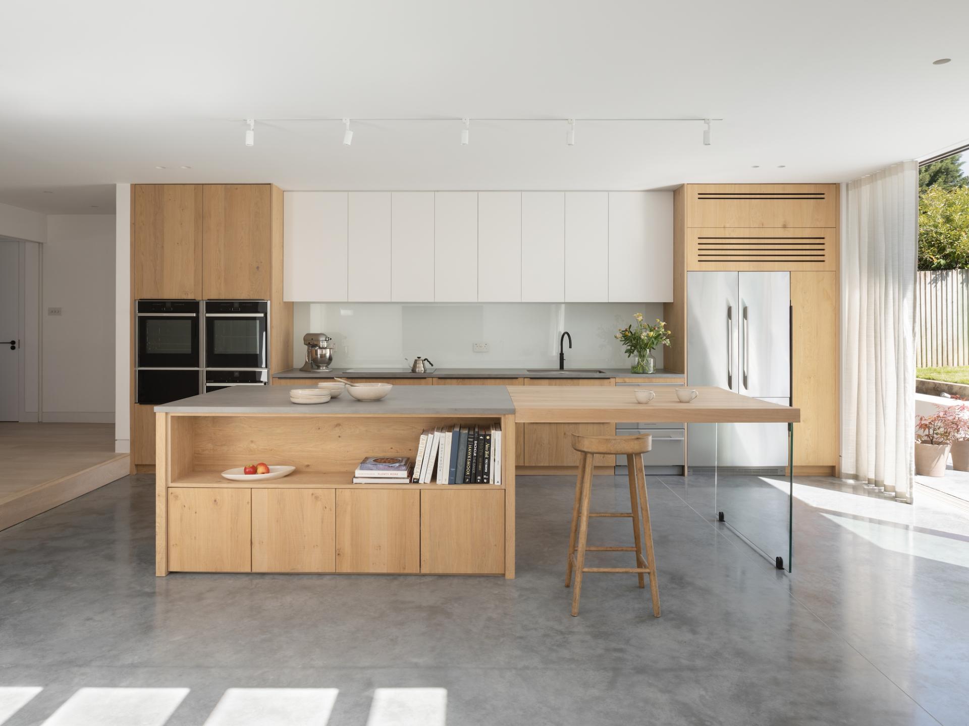 Modern kitchen design featuring a blend of wood and minimalist elements, enhancing the serene living atmosphere in Epsom.