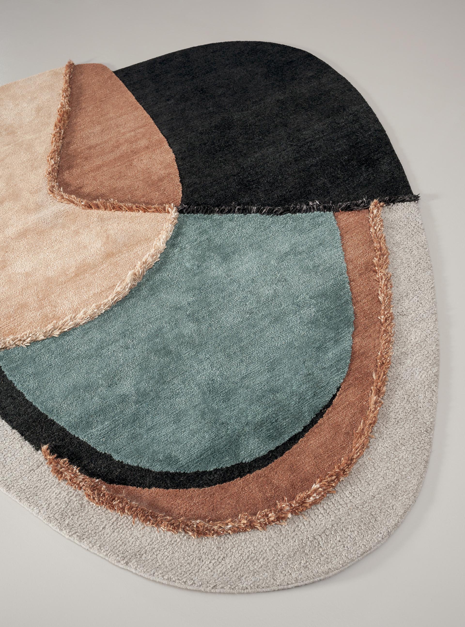 Colorful contemporary rug design featuring abstract shapes in muted tones, presented at Baxter Worldwide 2020 event in London.