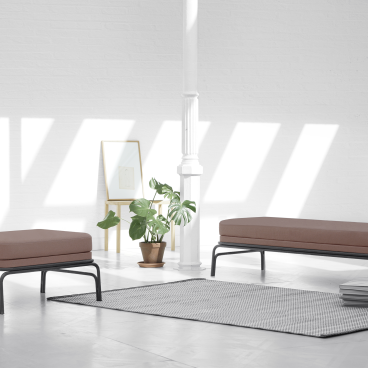 Minimalist seating from the Nudo Collection by OGSB Studio, featuring two handcrafted sofas in a bright, modern space.
