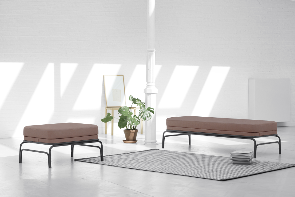 Minimalist seating from the Nudo Collection by OGSB Studio, featuring two handcrafted sofas in a bright, modern space.