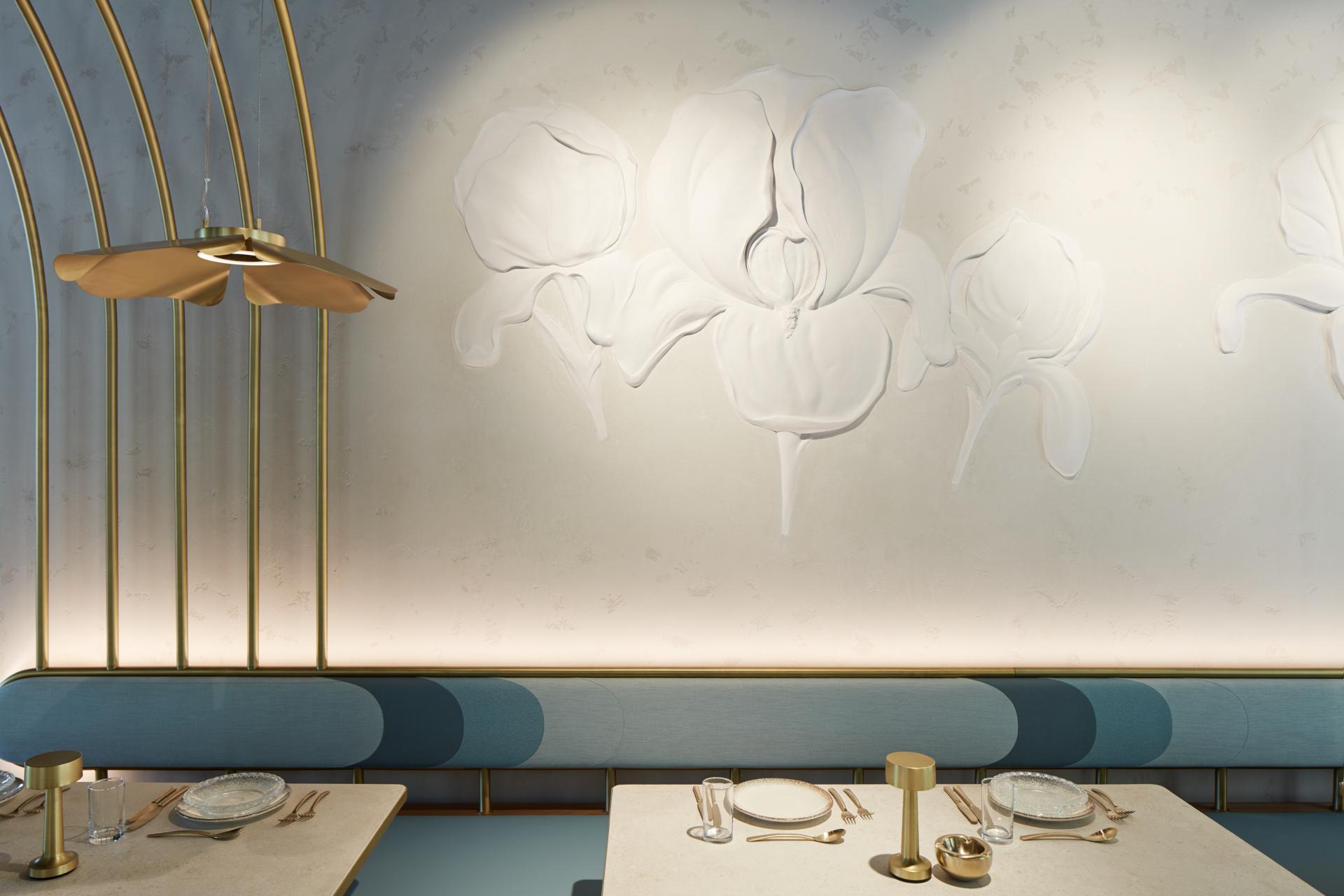 Contemporary dining area at Mezza House featuring a floral accent wall design and elegant table settings.