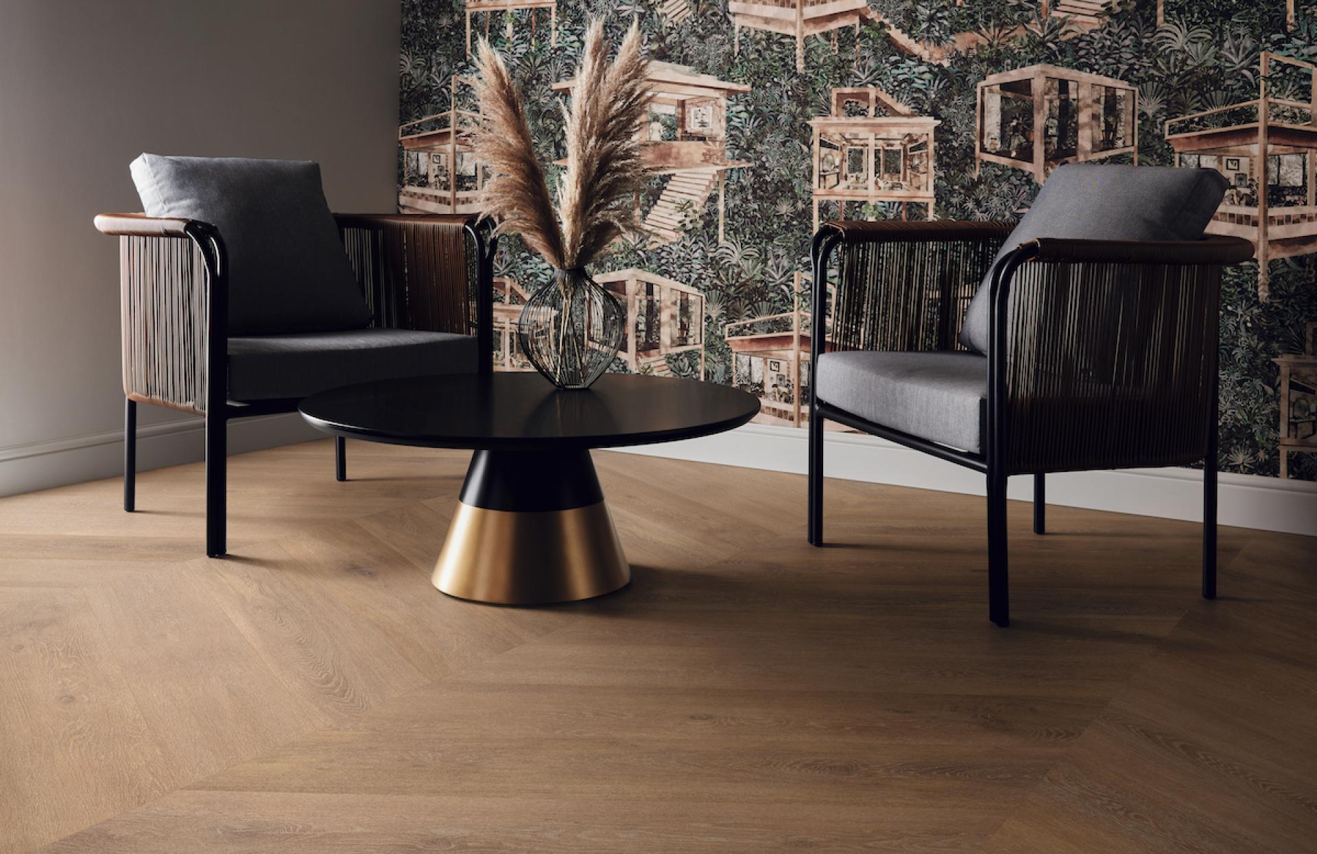 Stylish seating area featuring Karndean's Korlok Regent flooring, accentuated by a modern black table and decorative plants.