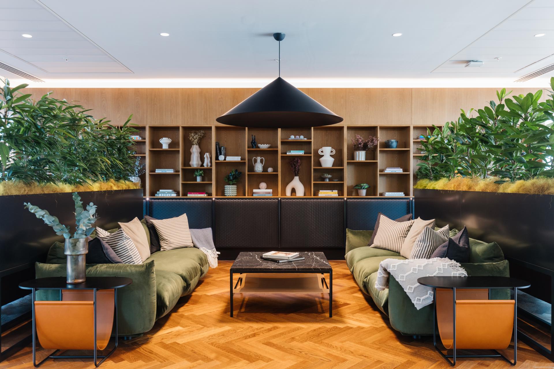 Stylish lounge area featuring contemporary furniture, greenery, and decorative elements, reflecting modern rental market aesthetics.