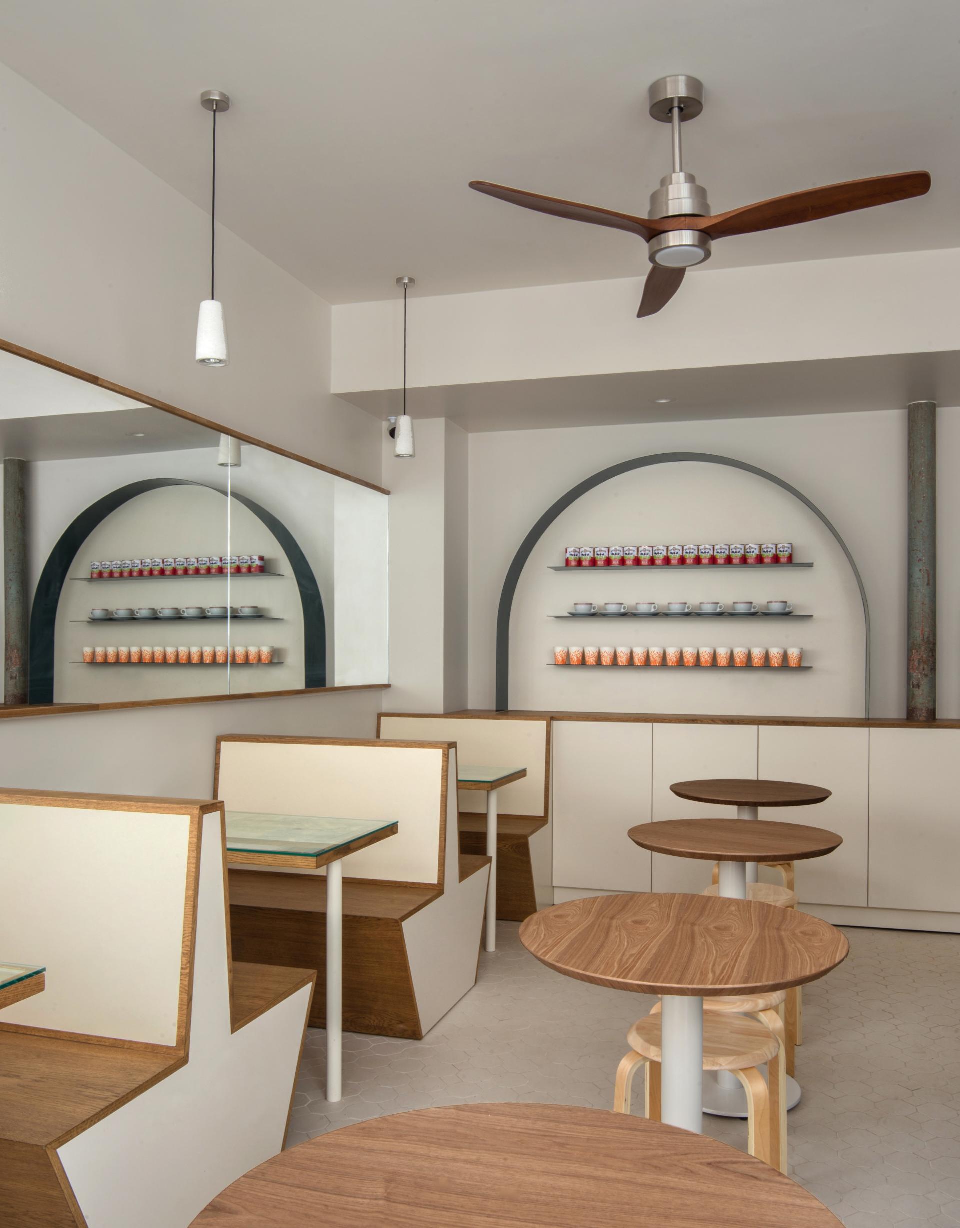 Modern Hong Kong Bing Sutt interior featuring minimalist wooden tables, creative seating, and colorful tableware in Paris.