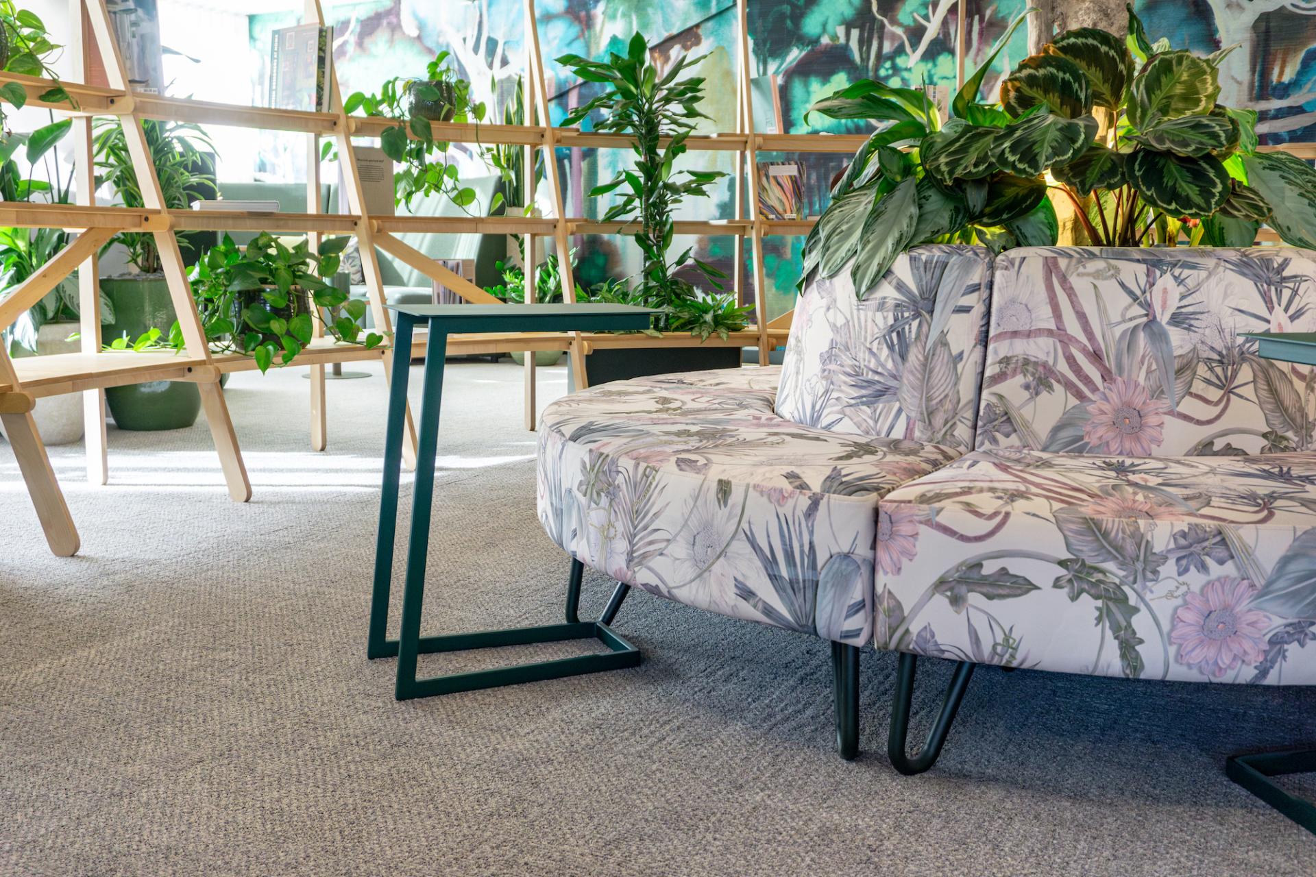 Vibrant seating area featuring floral-patterned furniture and greenery, enhancing collaboration and wellbeing at Crown Paints' Liz Hickson Academy.
